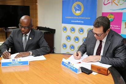 CTO secretary general Hugh Riley (left) and CDB president Dr Warren Smith sign partnership agreement at CDB headquarters