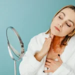 Woman applying cosmetics on a glowcation trip.